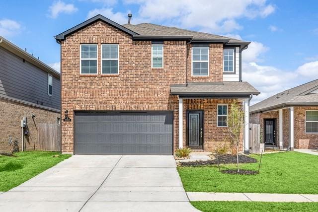23242 Spring Genesis Ln, Katy, TX 77493 - traditional-style home featuring an attached garage, brick siding, and concrete driveway