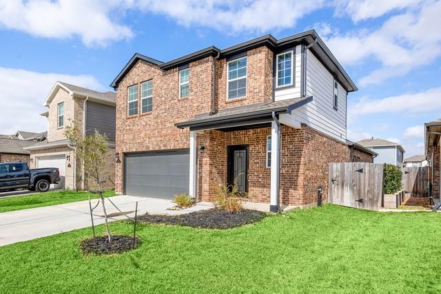 23242 Spring Genesis Ln, Katy, TX 77493 - view of front of property with a garage, brick siding, and concrete driveway