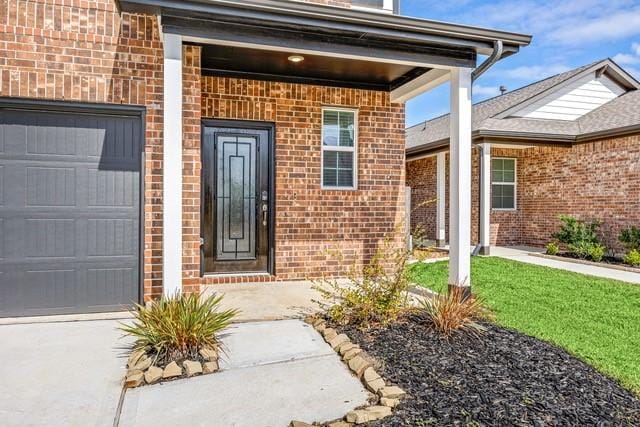 23242 Spring Genesis Ln, Katy, TX 77493 - doorway to property with brick siding, a garage, and driveway