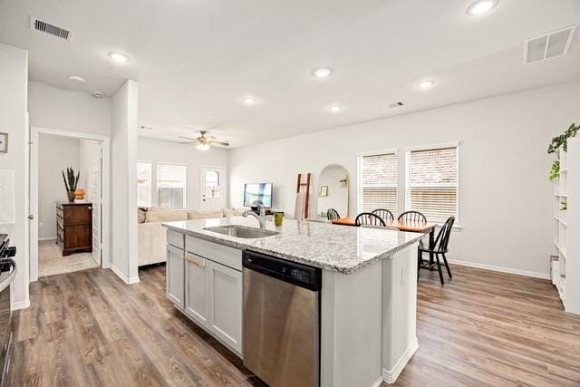 23242 Spring Genesis Ln, Katy, TX 77493 - kitchen featuring stainless steel appliances, light wood finished floors, an island with sink, light stone counters, and recessed lighting