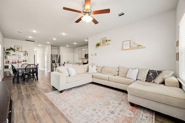 23242 Spring Genesis Ln, Katy, TX 77493 - living area featuring a ceiling fan, wood finished floors, and recessed lighting