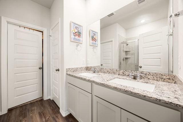 23242 Spring Genesis Ln, Katy, TX 77493 - full bathroom with a shower stall, double vanity, and wood finished floors
