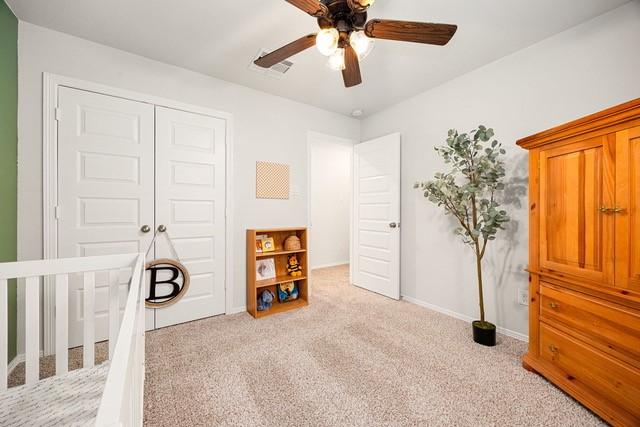 23242 Spring Genesis Ln, Katy, TX 77493 - carpeted bedroom featuring a closet and a ceiling fan
