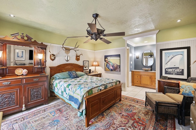12148 Stone W Dr, Houston, TX 77035 - bedroom with a textured ceiling, light tile patterned floors, ensuite bath, and ceiling fan