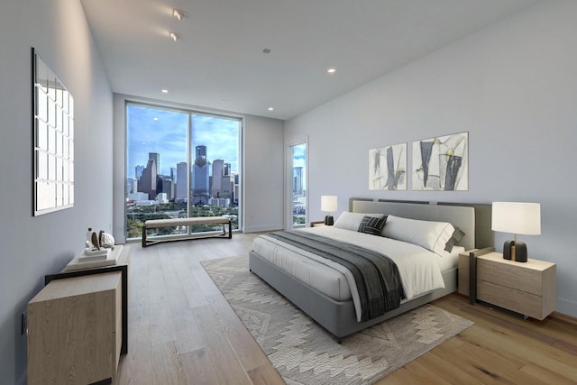 1711 Allen Pkwy Unit 2106, Houston, TX 77019 - bedroom featuring wood finished floors, a view of skyline, expansive windows, access to exterior, and recessed lighting