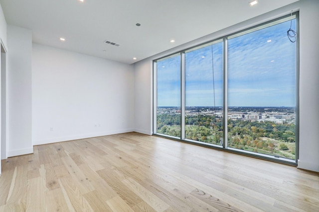 1711 Allen Pkwy Unit 2106, Houston, TX 77019 - empty room with a wall of windows, wood finished floors, and recessed lighting