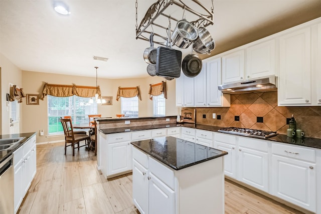 13330 Via Torre De Pisa Ln, Cypress, TX 77429 - kitchen with appliances with stainless steel finishes, under cabinet range hood, plenty of natural light, and dark countertops