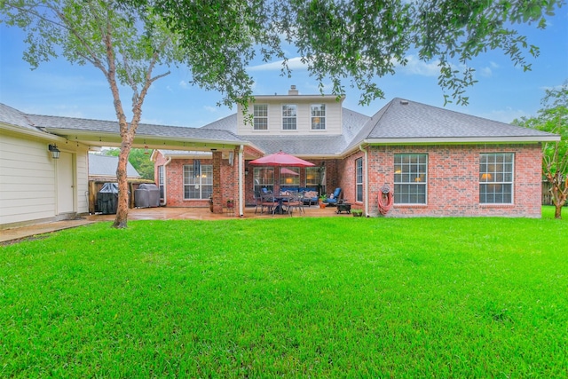 13330 Via Torre De Pisa Ln, Cypress, TX 77429 - rear view of property featuring a patio area, brick siding, a chimney, and a shingled roof