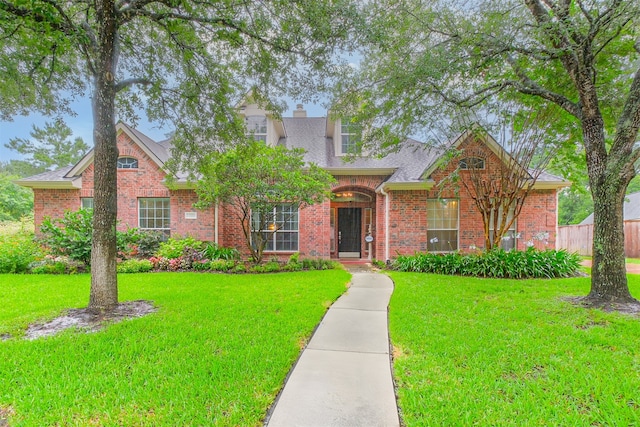 13330 Via Torre De Pisa Ln, Cypress, TX 77429 - traditional-style house featuring brick siding, a shingled roof, and a chimney