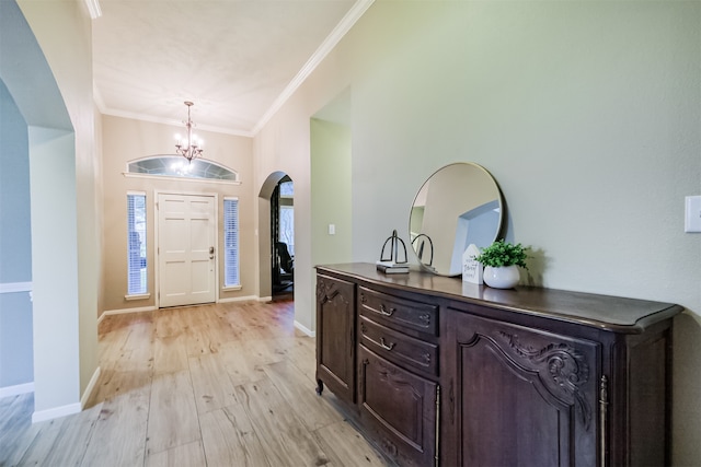 13330 Via Torre De Pisa Ln, Cypress, TX 77429 - entrance foyer with arched walkways, a chandelier, crown molding, and light wood finished floors