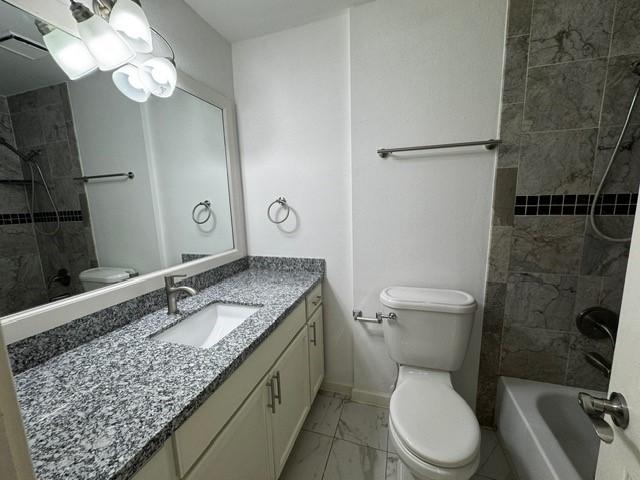 16310 Meadowbrook Farm Rd, Houston, TX 77082 - bathroom featuring marble look tiles, vanity, and  shower combination