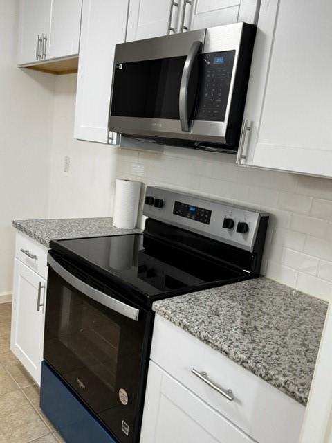 16310 Meadowbrook Farm Rd, Houston, TX 77082 - kitchen with stainless steel appliances, decorative backsplash, light stone countertops, and white cabinets