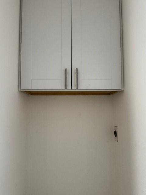 16310 Meadowbrook Farm Rd, Houston, TX 77082 - laundry room with hookup for an electric dryer and cabinet space