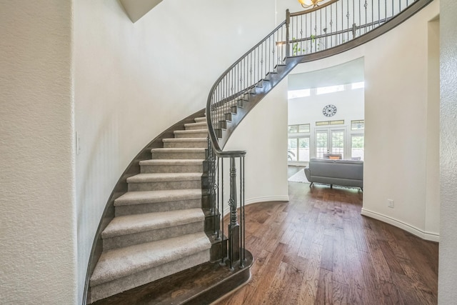 47 Chestnut Meadow Dr, Conroe, TX 77384 - stairs featuring wood finished floors and a towering ceiling