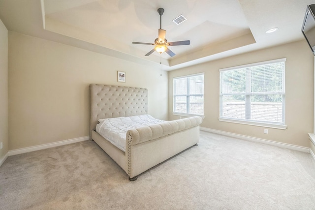 47 Chestnut Meadow Dr, Conroe, TX 77384 - bedroom featuring a raised ceiling, light colored carpet, and ceiling fan
