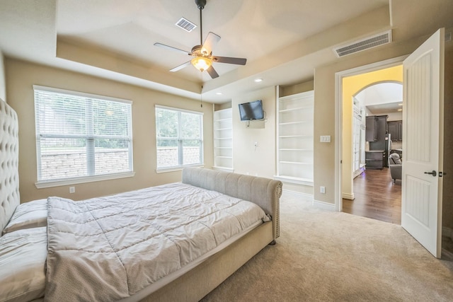 47 Chestnut Meadow Dr, Conroe, TX 77384 - carpeted bedroom with arched walkways, a raised ceiling, and recessed lighting