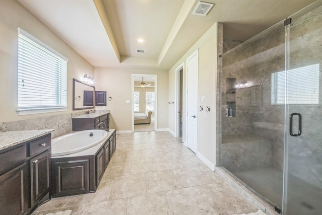 47 Chestnut Meadow Dr, Conroe, TX 77384 - ensuite bathroom with vanity, a shower stall, a garden tub, a raised ceiling, and tile patterned flooring