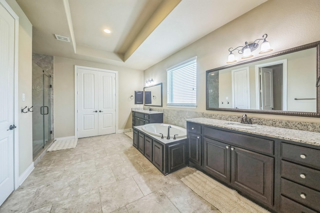 47 Chestnut Meadow Dr, Conroe, TX 77384 - bathroom featuring two vanities, a shower stall, a garden tub, and a raised ceiling