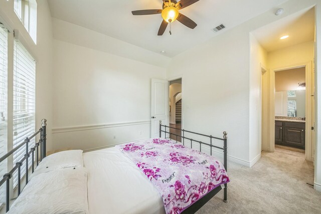 47 Chestnut Meadow Dr, Conroe, TX 77384 - bedroom featuring multiple windows, light carpet, arched walkways, and a ceiling fan