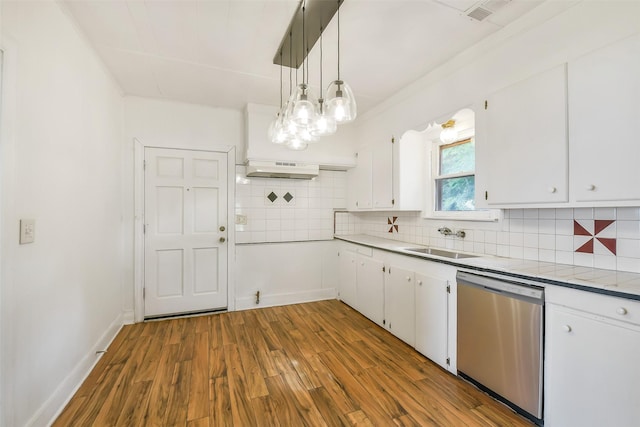 702 Caplin St, Houston, TX 77022 - kitchen with stainless steel dishwasher, wood finished floors, white cabinetry, and light countertops