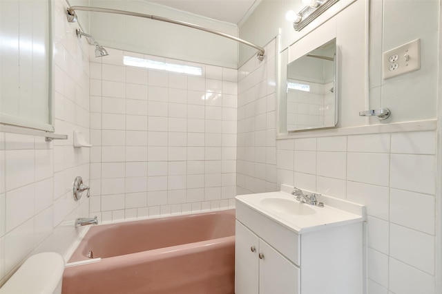 702 Caplin St, Houston, TX 77022 - bathroom with tile walls, vanity, shower / bath combination, crown molding, and tasteful backsplash
