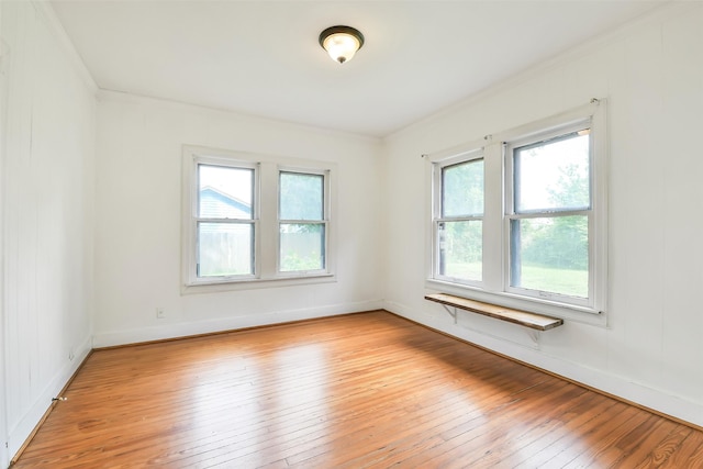 702 Caplin St, Houston, TX 77022 - spare room featuring light wood-style flooring and crown molding