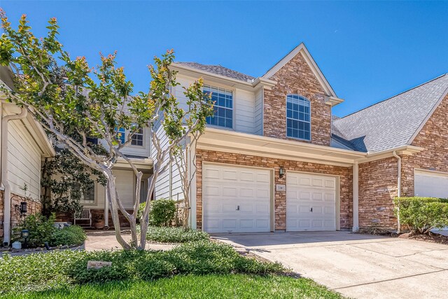 7210 Welshwood Ln, Sugar Land, TX 77479 - view of front of house featuring a garage, roof with shingles, concrete driveway, and stone siding