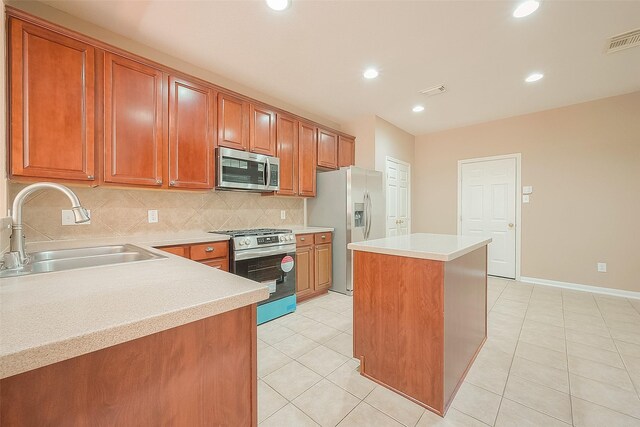 7210 Welshwood Ln, Sugar Land, TX 77479 - kitchen with appliances with stainless steel finishes, tasteful backsplash, a center island, brown cabinetry, and light countertops