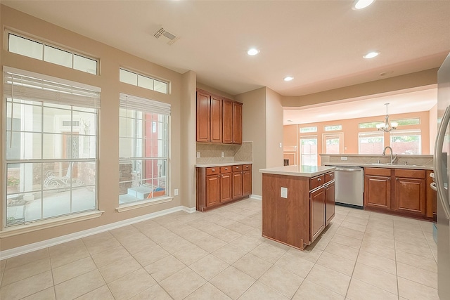 7210 Welshwood Ln, Sugar Land, TX 77479 - kitchen featuring stainless steel dishwasher, backsplash, recessed lighting, a center island, and a chandelier