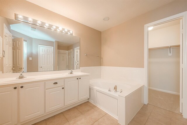 7210 Welshwood Ln, Sugar Land, TX 77479 - full bath featuring tile patterned floors, a bath, double vanity, a spacious closet, and a shower with door