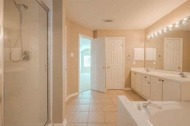7210 Welshwood Ln, Sugar Land, TX 77479 - full bathroom featuring a stall shower, double vanity, tile patterned flooring, and a garden tub