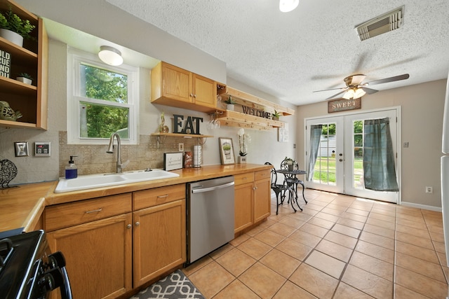 17715 Butera Rd, Magnolia, TX 77355 - kitchen with open shelves, stainless steel dishwasher, stove, french doors, and a textured ceiling