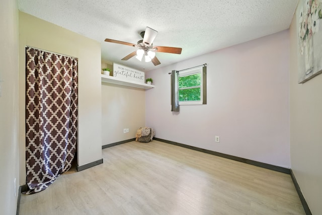 17715 Butera Rd, Magnolia, TX 77355 - empty room with light wood-style flooring, ceiling fan, and a textured ceiling