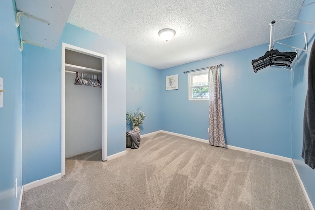 17715 Butera Rd, Magnolia, TX 77355 - unfurnished bedroom featuring carpet, a textured ceiling, and a closet