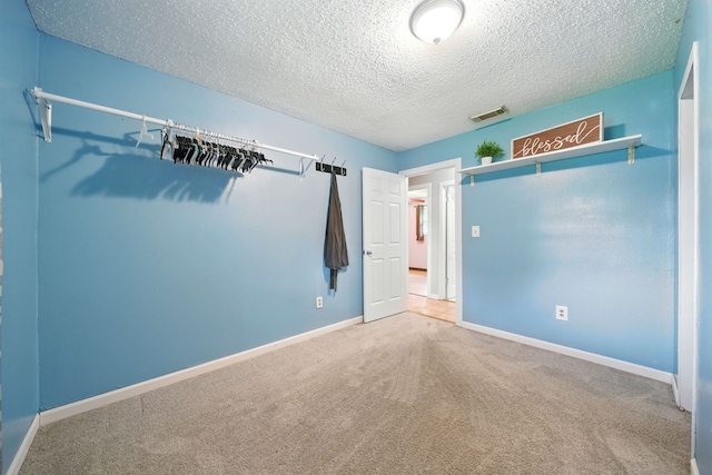 17715 Butera Rd, Magnolia, TX 77355 - unfurnished bedroom with a textured ceiling and carpet
