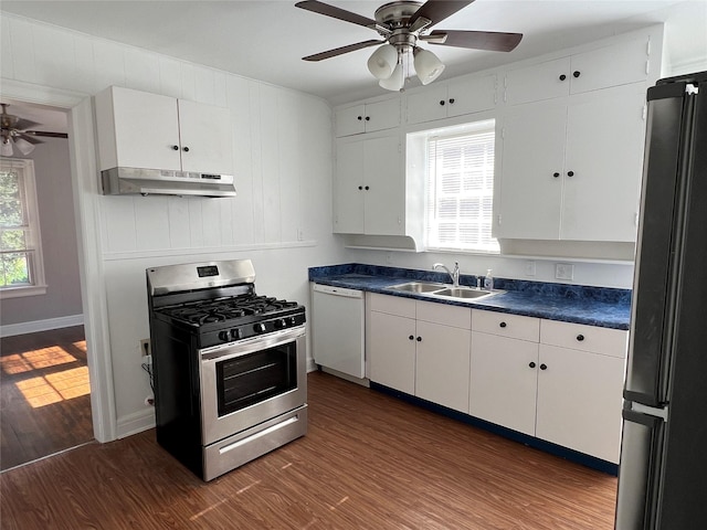 4905 Jackson St, Houston, TX 77004 - kitchen with stainless steel gas stove, dishwasher, under cabinet range hood, freestanding refrigerator, and dark wood-style floors