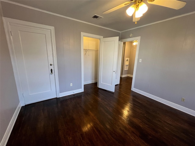 4905 Jackson St, Houston, TX 77004 - unfurnished bedroom featuring dark wood-style floors, ornamental molding, a ceiling fan, and a closet