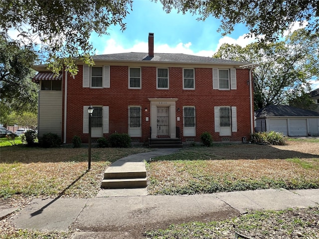 4905 Jackson St, Houston, TX 77004 - view of front of home with a chimney, a front yard, brick siding, and a garage