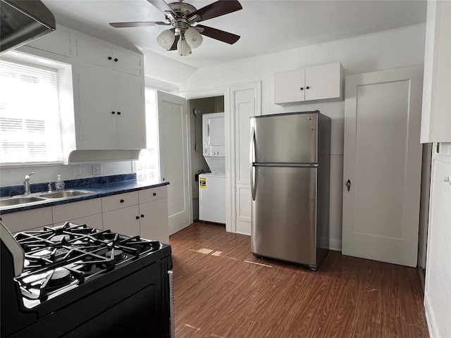 4905 Jackson St, Houston, TX 77004 - kitchen featuring freestanding refrigerator, black range with gas cooktop, wood finished floors, dark countertops, and ceiling fan