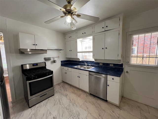 4905 Jackson St, Houston, TX 77004 - kitchen with stainless steel appliances, under cabinet range hood, dark countertops, and white cabinets
