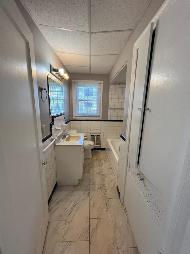 4905 Jackson St, Houston, TX 77004 - full bath with a drop ceiling, a tub, vanity, tile walls, and marble look tiles