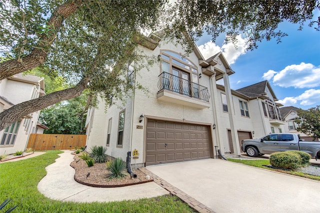 1415 Baldwin Square Ln, Houston, TX 77077 - view of front of property featuring a balcony, concrete driveway, an attached garage, and stucco siding