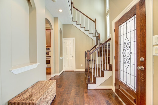 1415 Baldwin Square Ln, Houston, TX 77077 - entryway with arched walkways, dark wood-style floors, and stairway