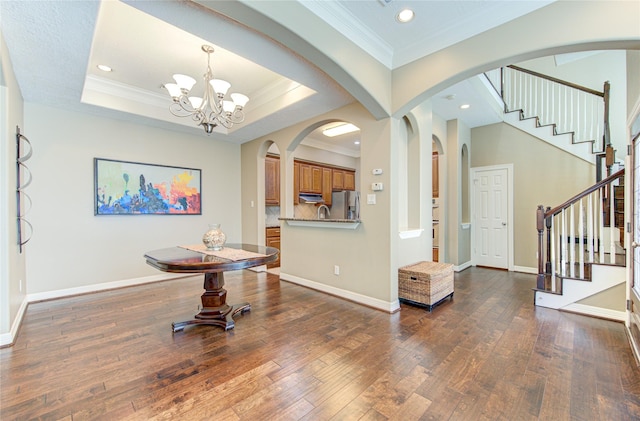 1415 Baldwin Square Ln, Houston, TX 77077 - foyer entrance with a chandelier, ornamental molding, hardwood / wood-style floors, stairway, and arched walkways