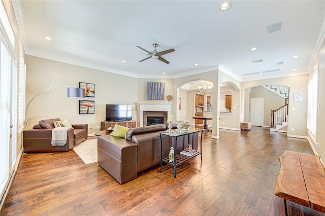 1415 Baldwin Square Ln, Houston, TX 77077 - living area featuring arched walkways, wood finished floors, a ceiling fan, a glass covered fireplace, and recessed lighting