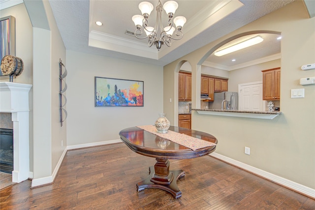 1415 Baldwin Square Ln, Houston, TX 77077 - dining space with arched walkways, ornamental molding, a chandelier, dark wood-type flooring, and recessed lighting
