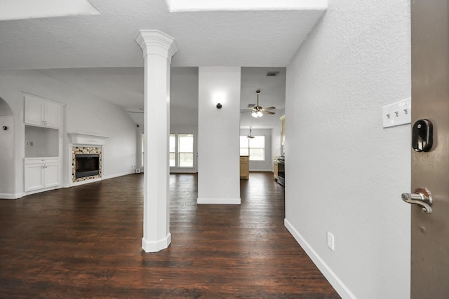 204 Audubon Woods Ct, Richwood, TX 77531 - unfurnished living room featuring ceiling fan, a fireplace, dark wood-style flooring, and a textured ceiling