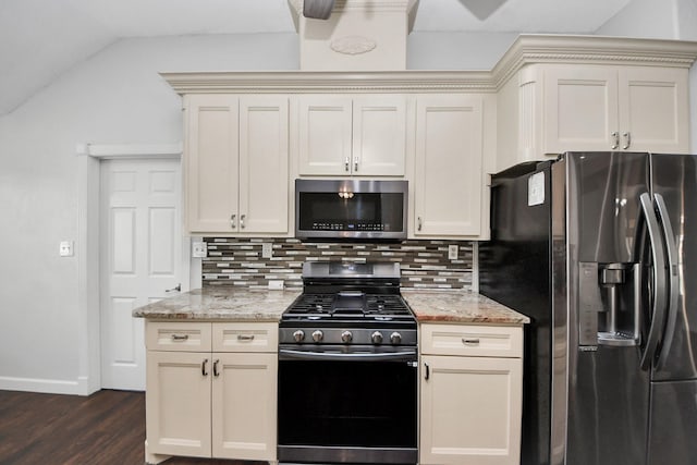 204 Audubon Woods Ct, Richwood, TX 77531 - kitchen featuring appliances with stainless steel finishes, decorative backsplash, dark wood finished floors, light stone countertops, and vaulted ceiling