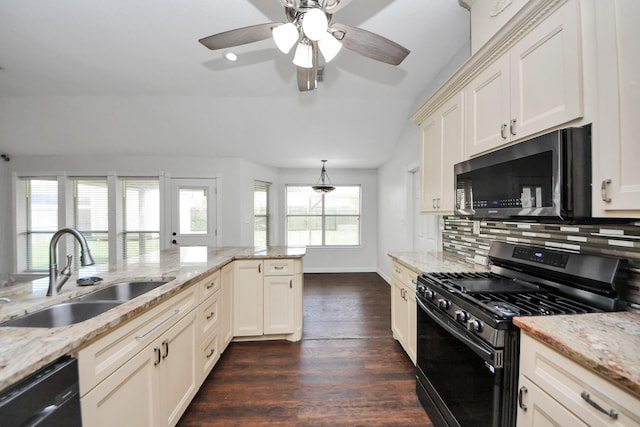 204 Audubon Woods Ct, Richwood, TX 77531 - kitchen featuring black appliances, dark wood-type flooring, backsplash, vaulted ceiling, and light stone counters
