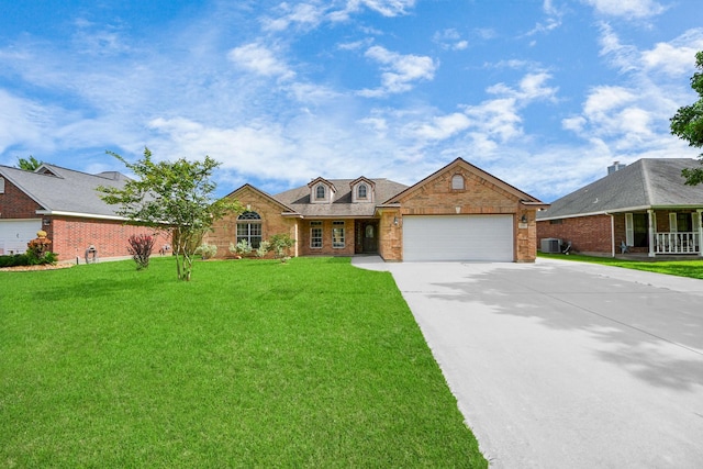 204 Audubon Woods Ct, Richwood, TX 77531 - view of front of house with brick siding, an attached garage, driveway, and a front yard
